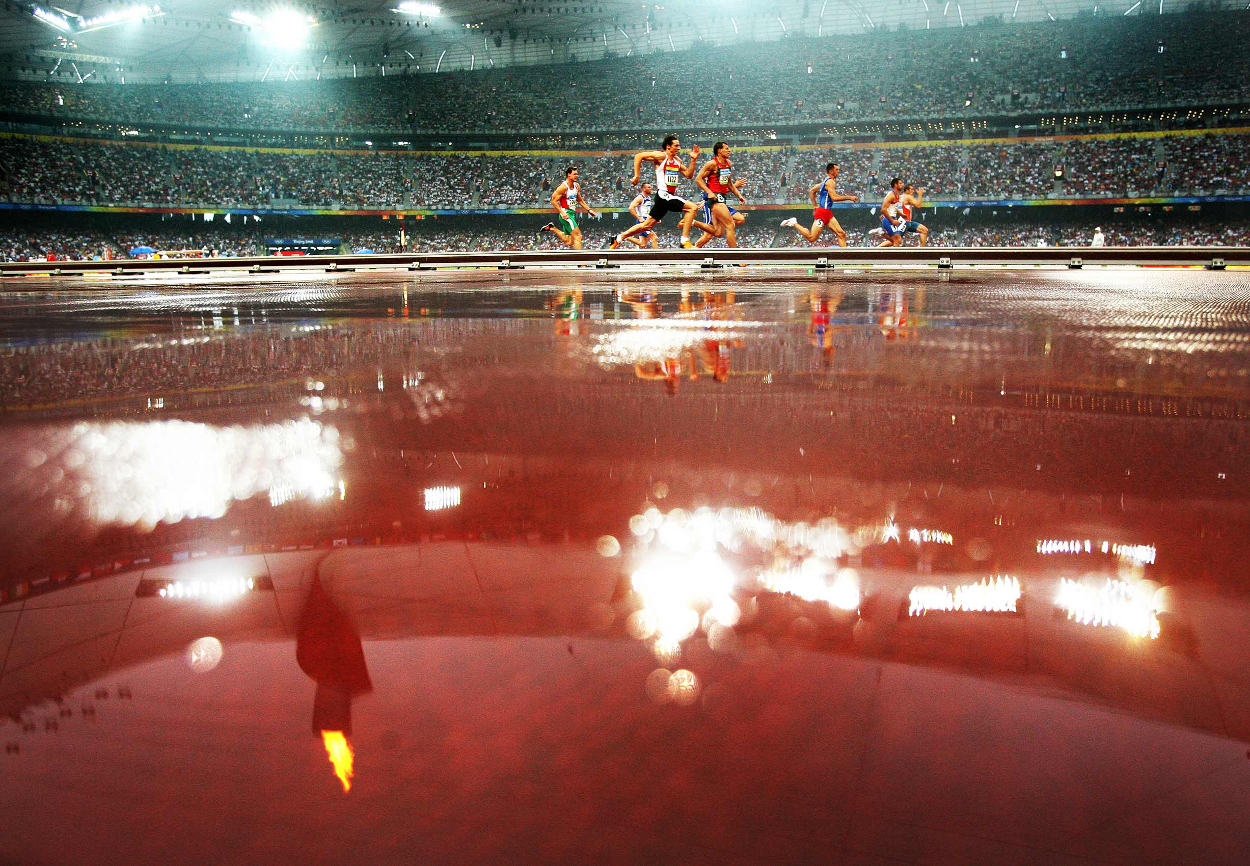   Beijing Olympics 2008. Day 13. Athletics. Heat six in the rain of the 100m Men
